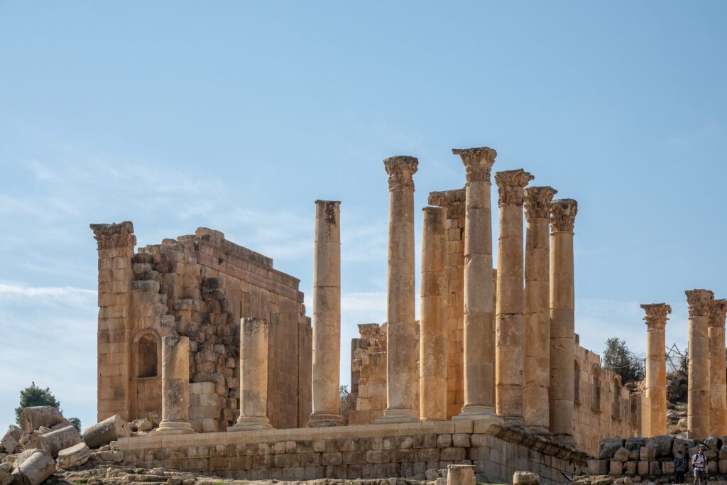 A wide angle shot of an ancient building with towers in Jerash, Jordan